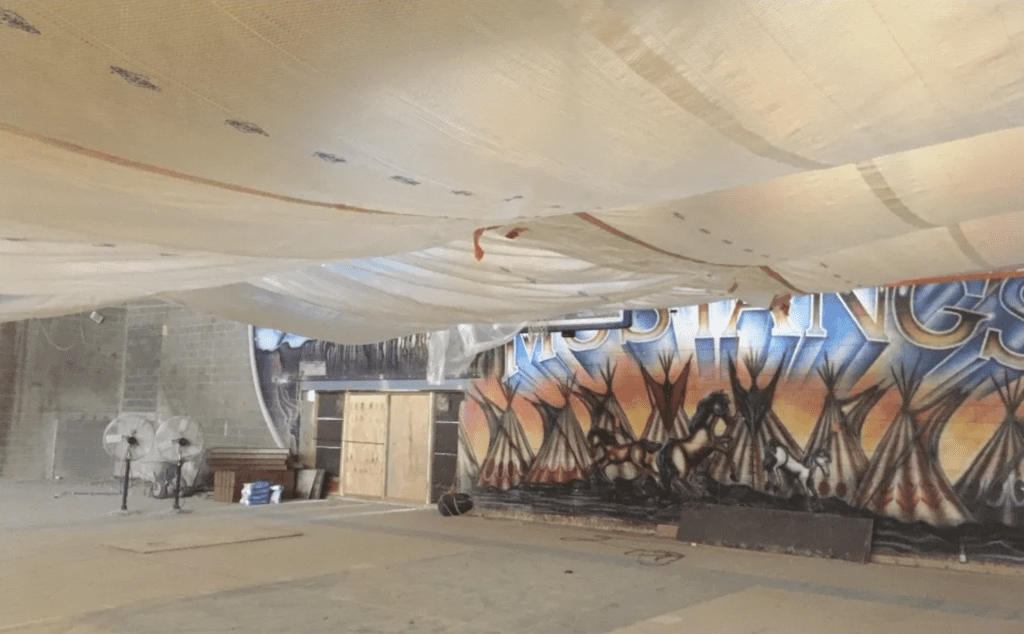 Building interior with plastic sheeting draped from the roof