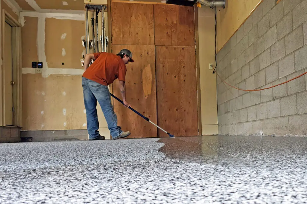 Brushing Epoxy Onto Flake Coating for Concrete Floor in a Garage