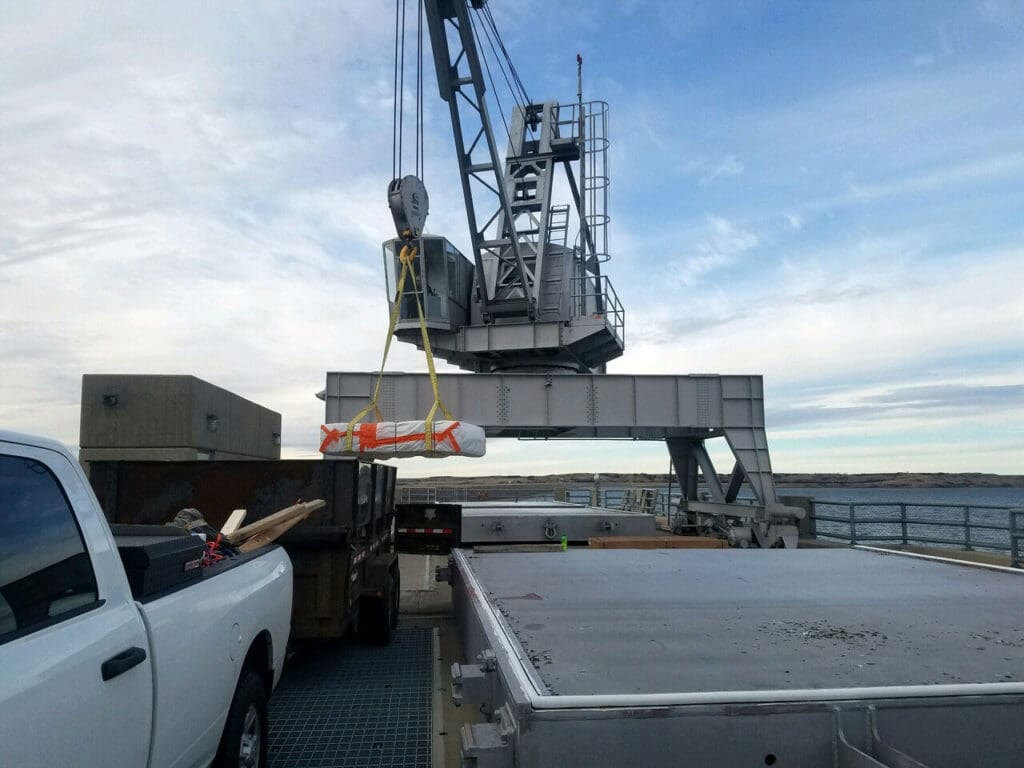 Crane lifting properly contained lead and asbestos off of a cargo ship.
